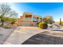 Daytime view of a modern home with a large driveway and native desert landscaping at 15501 E Tepee Dr, Fountain Hills, AZ 85268