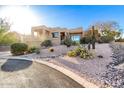 Daytime view of the front of home with desert landscaping, including cacti and succulents at 15501 E Tepee Dr, Fountain Hills, AZ 85268