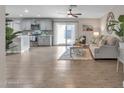 Open-concept living room with wood floors, and a neutral color scheme creating a warm and inviting atmosphere at 16239 N 47Th Dr, Glendale, AZ 85306