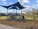 Community playground equipment with shade and climbing structures and mountain views at 17809 W Elm St, Goodyear, AZ 85395