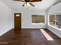 Bright living room with hardwood floors and a large window with natural light at 1805 E Bluefield Ave, Phoenix, AZ 85022