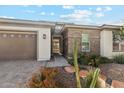 Close-up of home's entryway featuring brick accents and desert landscaping at 2081 E Aquarius Pl, Chandler, AZ 85249