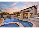 Outdoor oasis featuring pool, spa, built-in grill and covered patio area at 22317 N 39Th Run, Phoenix, AZ 85050