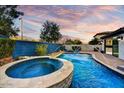 A stunning backyard with a pool, spa, and rock waterfall features at 22317 N 39Th Run, Phoenix, AZ 85050