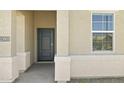 Inviting front entry with a gray door and natural light from a nearby window at 23957 W Papago St, Buckeye, AZ 85326