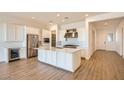 Modern kitchen featuring white cabinets, stainless steel appliances, and a large center island at 25180 N 177Th Dr, Surprise, AZ 85387