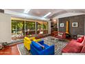 Bright living room featuring mid-century modern furniture, concrete accent wall and access to a large outdoor space at 3237 E Meadowbrook Ave, Phoenix, AZ 85018