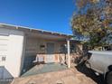 Charming front porch with chairs on a sunny day, accented by a mature tree at 3932 W Bethany Home Rd, Phoenix, AZ 85019