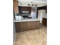 A kitchen featuring wood cabinets, a speckled countertop, and stainless steel appliances at 4107 E Charter Oak N Rd, Phoenix, AZ 85032