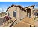 Charming home exterior with desert landscaping, inviting entrance, and lovely architectural details at 43611 N 1St Dr, New River, AZ 85087