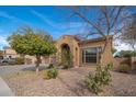 View of a one story home with desert landscaping in front and an arched entrance at 4485 N 152Nd Dr, Goodyear, AZ 85395