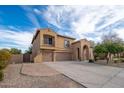 Charming two-story home with a three-car garage, balcony, and mature desert landscaping at 4485 N 152Nd Dr, Goodyear, AZ 85395