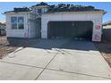 New construction home featuring stone accents, large window, and garage at 469 W Freedom St, Florence, AZ 85132