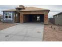 A home under construction featuring a spacious driveway and a modern architectural design with ample garage space at 469 W Freedom St, Florence, AZ 85132