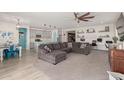 Open concept living space with modern gray color palette and a ceiling fan at 5325 N 188Th Ave, Litchfield Park, AZ 85340