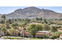 Expansive property featuring a beautiful home with a red tile roof, lush landscaping and scenic mountain views at 5827 E Sanna St, Paradise Valley, AZ 85253