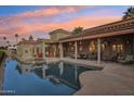 Luxurious backyard oasis featuring a sparkling pool, covered patio and outdoor seating perfect for entertaining guests at 5827 E Sanna St, Paradise Valley, AZ 85253