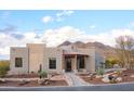 Exterior of a luxury single-Gathering home with desert landscaping and mountain views in the background at 6038 E Agave Cir, Carefree, AZ 85377