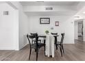 Bright dining area features black table and chairs, and decor on the white walls at 628 Leisure World --, Mesa, AZ 85206