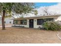 Charming single-story home with manicured lawn, blooming bougainvillea, and a welcoming front porch at 7006 N 14Th Ave, Phoenix, AZ 85021