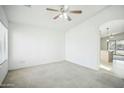 A bedroom with white walls, a ceiling fan, and a window offering natural light at 7557 W Colter St, Glendale, AZ 85303