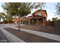 Charming two-story home with a three car garage and low-water landscaping at 8776 W Peppertree Ln, Glendale, AZ 85305