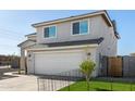 Two-story home featuring stucco siding, a two-car garage, and a fenced yard at 9050 S Calle Tomi --, Guadalupe, AZ 85283