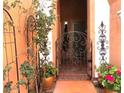 Lovely gated entrance adorned with wrought iron, flowers, and mature landscaping at , Gilbert, AZ 85234