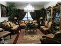 Elegant living room featuring decorative furniture, a chandelier, and large windows that provide natural light at , Gilbert, AZ 85234