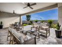 Inviting covered patio with stylish furniture, a ceiling fan, and outdoor grill area, perfect for entertaining at 10308 S Bickwell Trl, Apache Junction, AZ 85120