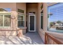 Home entryway featuring a well-lit porch, address marker, and inviting front door at 11258 E Ocaso Ave, Mesa, AZ 85212