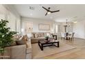 Spacious living room with tan sofa set, ceiling fan and an open view into the dining area and kitchen at 11500 E Cochise Dr # 1090, Scottsdale, AZ 85259