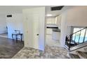 A bright foyer features neutral flooring, white walls, and a glimpse into the updated kitchen at 1438 S 30Th St, Mesa, AZ 85204