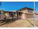 Charming home with tan siding, red brick accents, and a well-kept lawn under a clear blue sky at 1438 S 30Th St, Mesa, AZ 85204