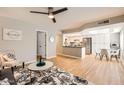 Open concept living space with hardwood floors connecting to the kitchen and dining area at 14849 N Kings Way # 111, Fountain Hills, AZ 85268