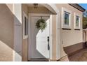 Charming white front door features a decorative wreath, sidelight windows and covered entry at 1576 E Jasper Ct # E, Gilbert, AZ 85296