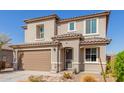 Attractive two-story home with a well-kept front yard and a two-car garage at 19242 W Madison St, Buckeye, AZ 85326