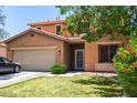 Charming two-story home features a well-maintained front lawn and a two-car garage at 20784 N Marina Ave, Maricopa, AZ 85139