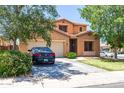 Charming two-story home features a well-maintained front lawn and a two-car garage at 20784 N Marina Ave, Maricopa, AZ 85139