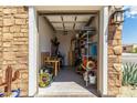 Organized garage with shelving, work table, and neatly stored tools and equipment at 27366 W Escuda Dr, Buckeye, AZ 85396