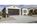 Charming single-story home with a brown garage door, blue accents, and desert landscaping at 35378 W Santa Barbara Ave, Maricopa, AZ 85138