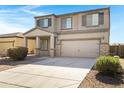 Attractive two-story home with desert landscaping, two-car garage, and a welcoming front porch at 38179 W La Paz St, Maricopa, AZ 85138