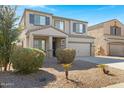 Charming two-story home with a well-kept yard, featuring desert landscaping and a two-car garage at 38179 W La Paz St, Maricopa, AZ 85138