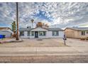 Inviting single-story home with well-maintained desert landscaping and cozy curb appeal at 3915 E Hillery Dr, Phoenix, AZ 85032