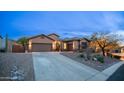 Beautiful home featuring a spacious driveway, three-car garage and desert landscaping at twilight at 4109 N Twilight Cir, Mesa, AZ 85207