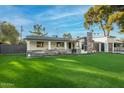 Charming single-story home featuring manicured lawn and a stone facade with a two-car garage at 4132 N 34Th Pl, Phoenix, AZ 85018