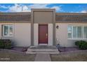 Close up view of a townhouse and its maroon front door and welcoming entryway at 4857 N Granite Reef Rd, Scottsdale, AZ 85251