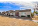 Delightful townhouse showcases tidy landscaping and a maroon front door with modern design at 4857 N Granite Reef Rd, Scottsdale, AZ 85251