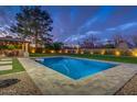 Backyard view featuring a rectangular pool, covered patio with outdoor seating, and mature trees at 5020 E Pershing Ave, Scottsdale, AZ 85254