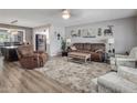 Cozy living room with a ceiling fan, comfortable seating, and an adjacent kitchen at 5061 E Edgewood Ave, Mesa, AZ 85206